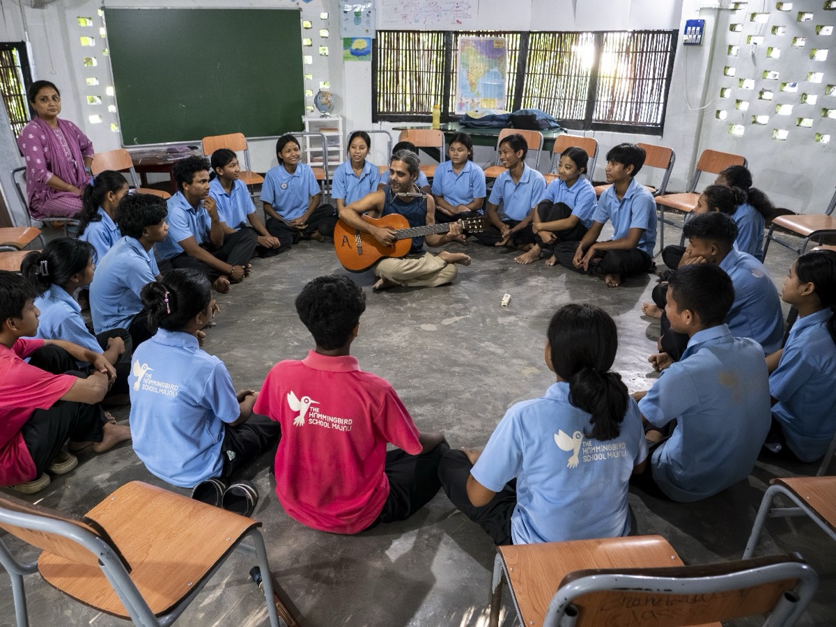 Students at Hummingbird School on Majuli Island gathered in a circle, learning through music and community